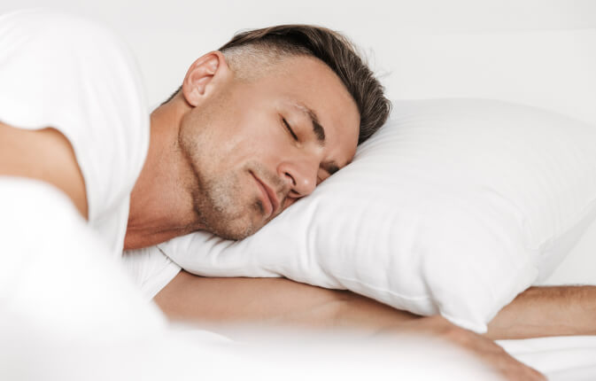 handsome-man-sleeping-in-bed-FLJR2K4 1 (1)